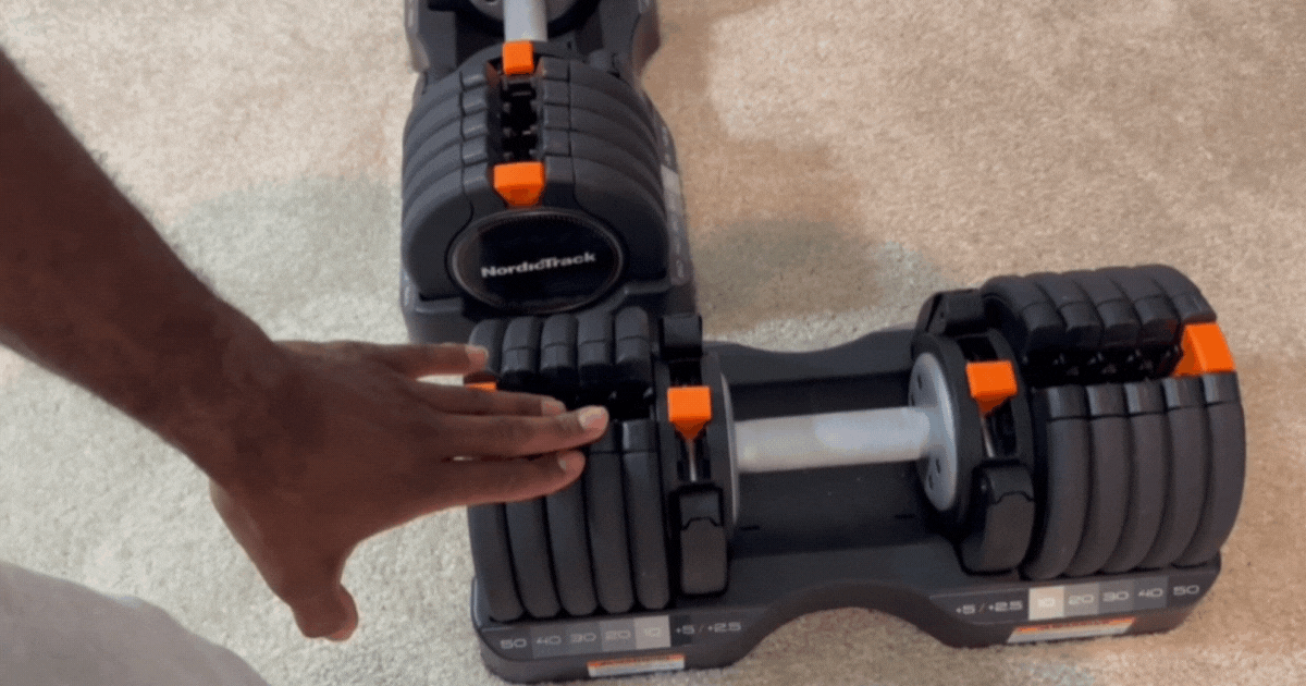 main pointing to the NordicTrack adjustable select a weight dumbbells preparing to test and review