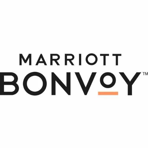 Logo of Marriott Bonvoy, featuring the text Marriott in smaller black letters above Bonvoy, with the o in Bonvoy having an orange underline. The overall design is simple and modern.