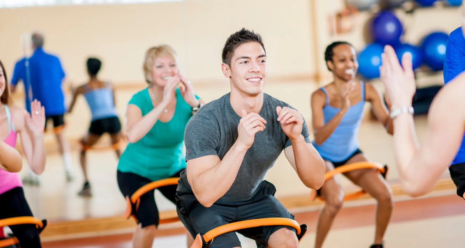 individuals of different ages doing group fitness classes