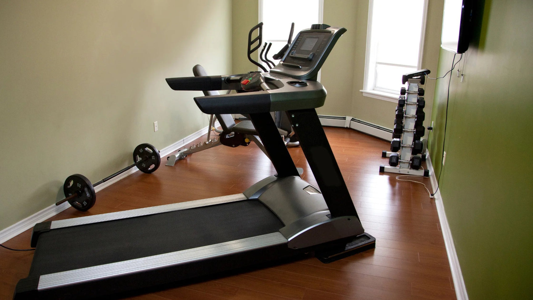 A full treadmill in a small home gym setup