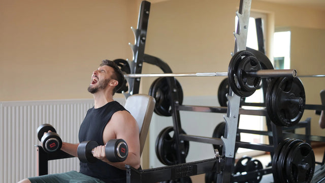 A man angrily doing bicep curls 