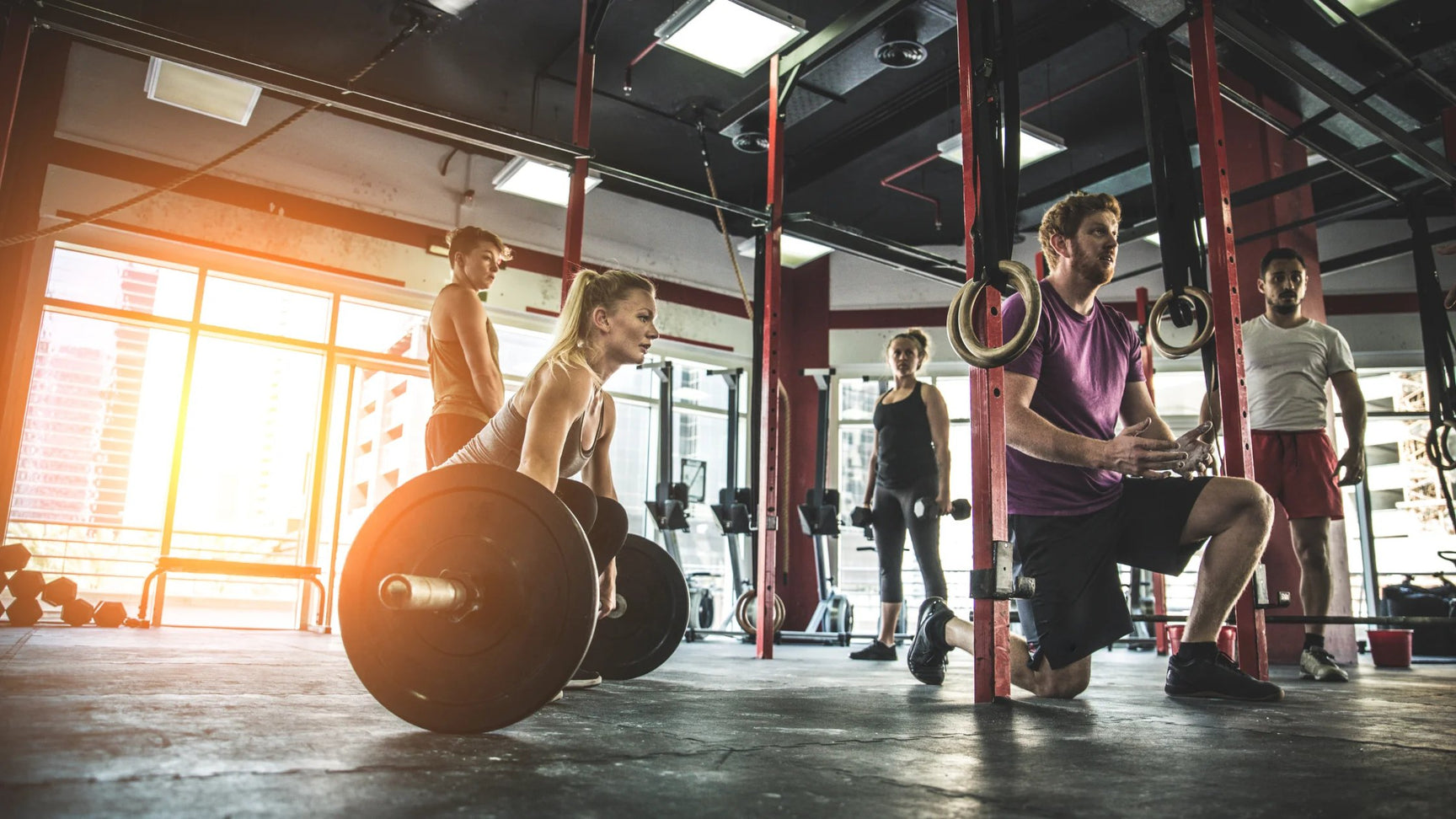 a group of individuals doing crossfit training in the gym