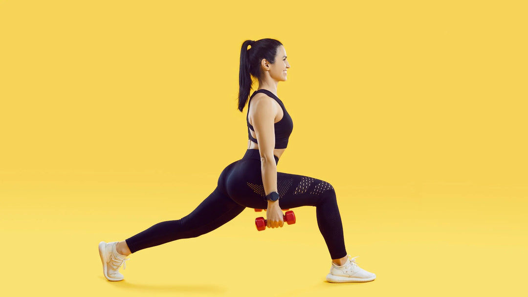 girl on yellow background doing dumbbell lunges for glute workout