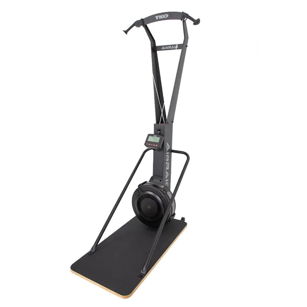 The TKO Strength AirRaid Ski Trainer (8ASKI) by TKO Strength offers realistic indoor skiing with advanced air resistance, double-pull capability, resistance cords, handlebars, and a digital monitor on a sleek black wooden base.