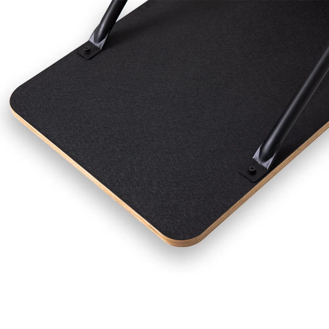 Close-up of the underside of a black table with curved black metal legs, resembling the TKO Strength AirRaid Ski Trainers (8ASKI) sleek design. The wooden-edged tabletop harmonizes functionality and style, akin to an advanced air resistance system from TKO Strength.