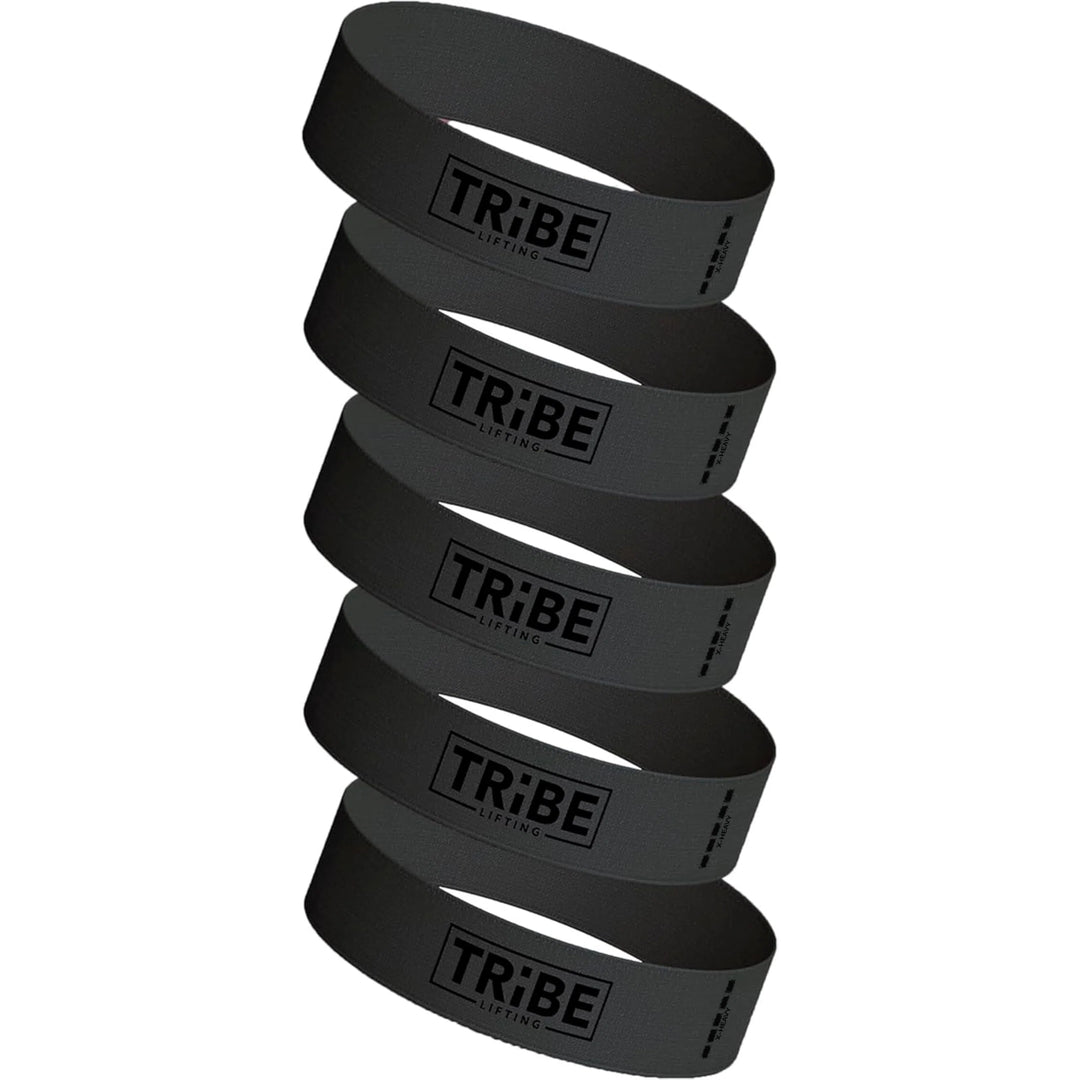 The Tribe Fabric Resistance Bands for Botty Workout is a sleek set of five stacked black bands, each displaying the Tribe insignia, blending style and functionality into your fitness regime.