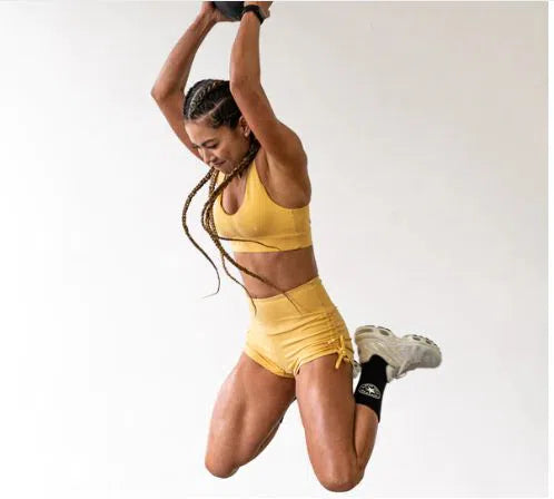 Athletic Woman Jumping and Slamming the AeroMat Slam Ball