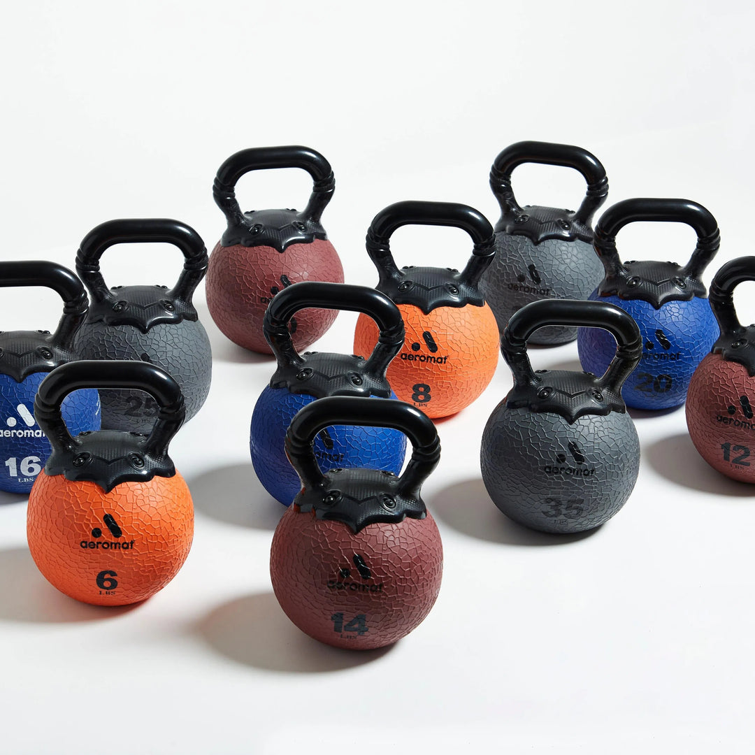 Aeromat Elite Rubber Kettlebell Set in 6, 8, 10, 12, 14, 16, 18, 20, 25, 30, 35 lbs all shown together.