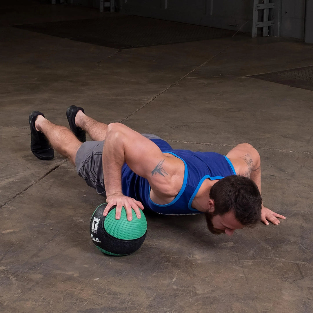 man alternating med ball pushup with Body-Solid Premium Medicine Ball BSTMB