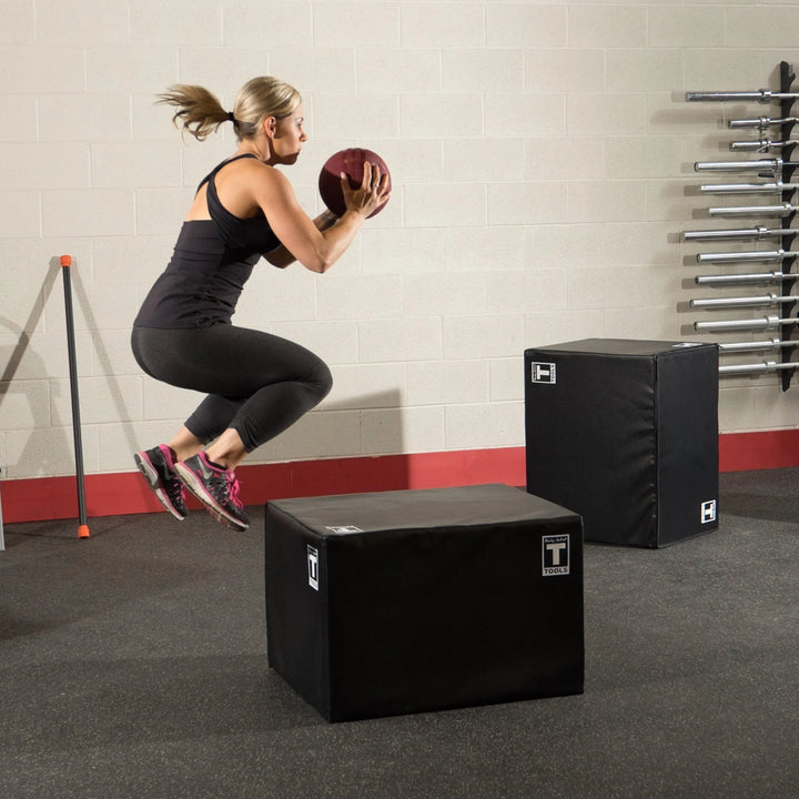 woman med ball jumps on the Body-Solid Soft Plyo Box BSTSPBOX