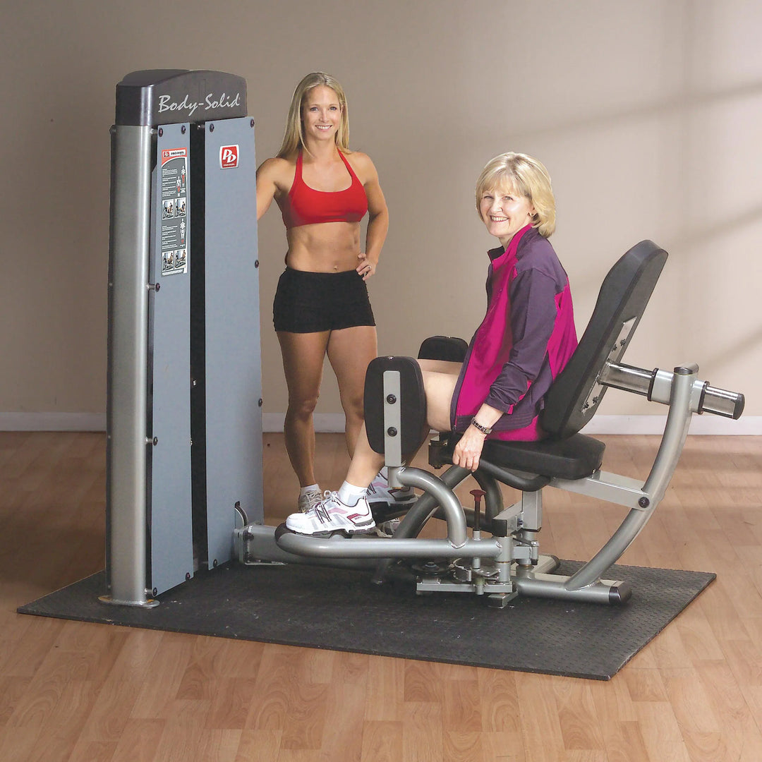 A young woman and a middle aged woman training on the Body-Solid Inner Outer Thigh Workout Machine DIOTSF