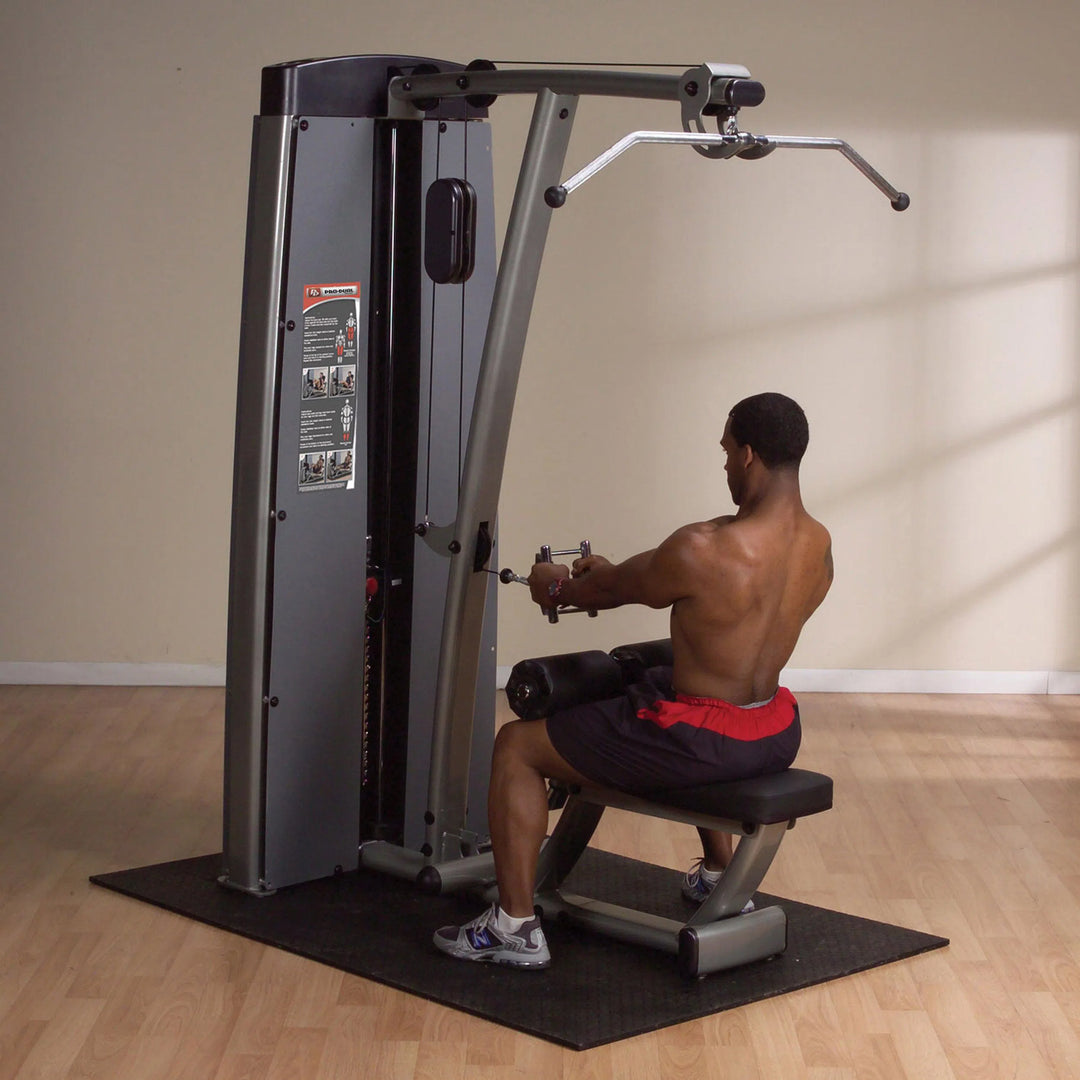 A man training on the Body-Solid Lat Pulldown and Row Machine DLATSF