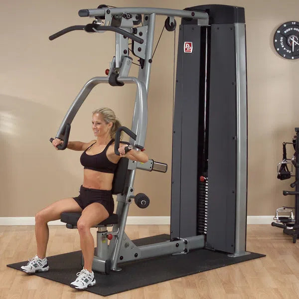 A woman training on the Body-Solid Chest and Back Machine DPLSSF