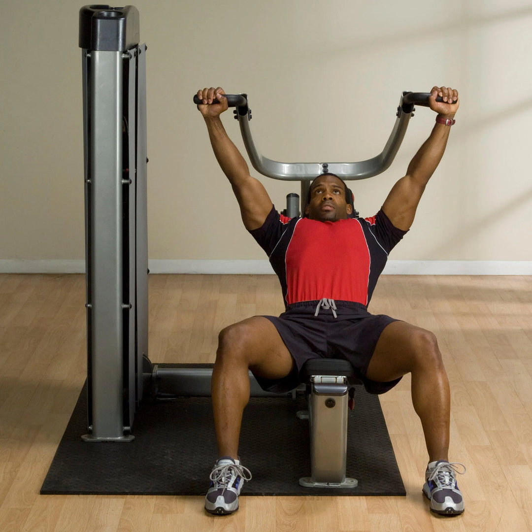A man doing chest press on the Body-Solid Multi-Press Machine DPRSSF