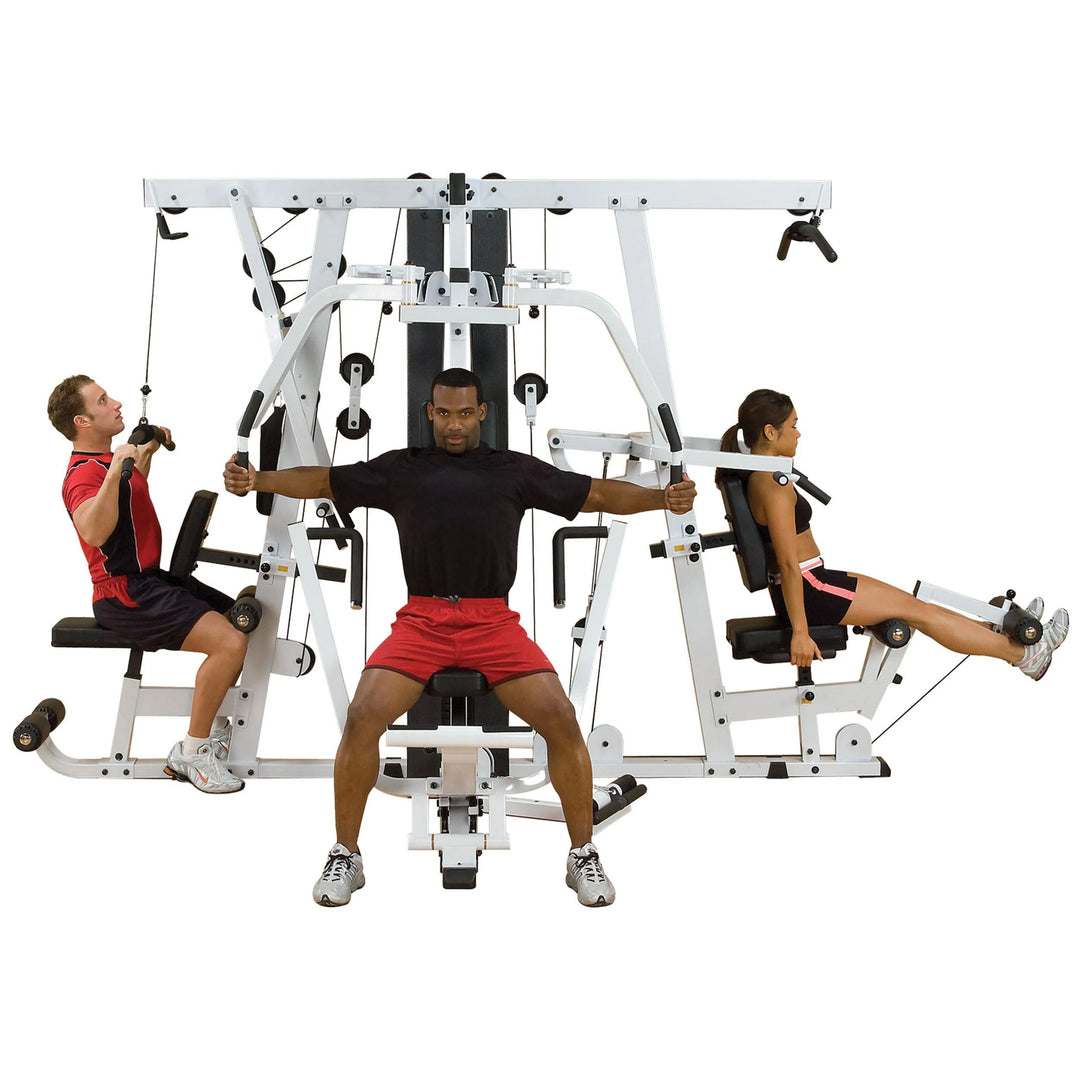 A group of three training together on the Body-Solid Universal Weight Machine with Leg Press EXM4000S