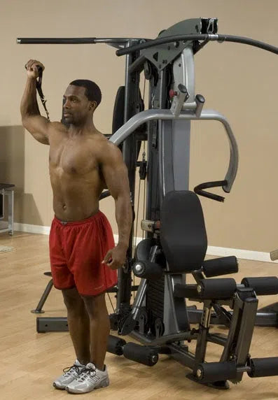 A man training on the Body-Solid Fusion Commercial Exercise Machine F500