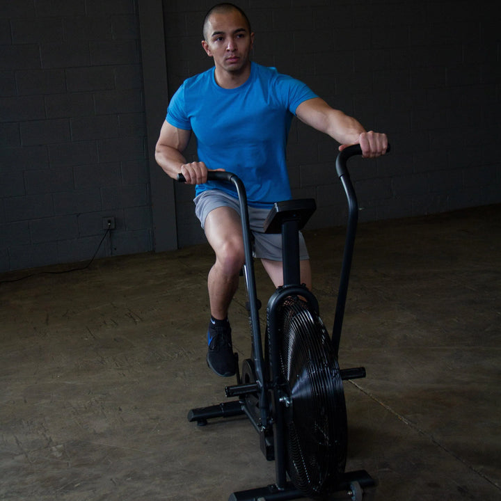 man training hard on Body-Solid Endurance Crossfit Air Bike FB300B