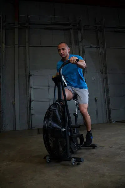 A man training on the Body-Solid Endurance Crossfit Air Bike FB300BA man training on the Body-Solid Endurance Crossfit Air Bike FB300B