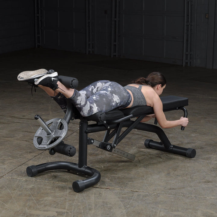 girl laying leg curl exercise on Body-Solid Adjustable Weight Bench with Leg Extension & Leg Curl FID46