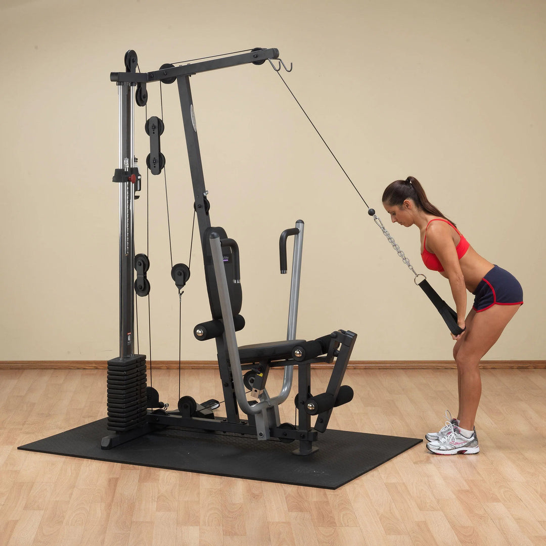 A woman training on the Body-Solid Compact Home Gym G1S