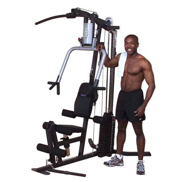 A man showcasing the Body-Solid All-In-One Gym Machine for Home G3S