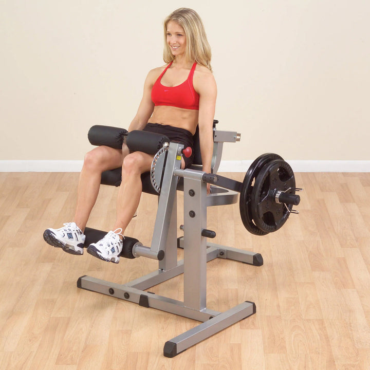 A woman training on the Body-Solid Leg Extension and Curl Machine GCEC340