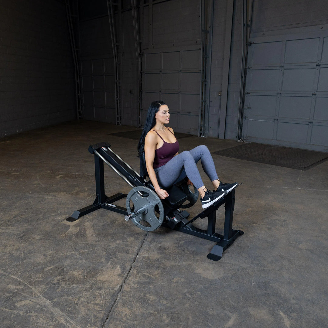 A woman training on the Body-Solid Compact Leg Press GCLP100
