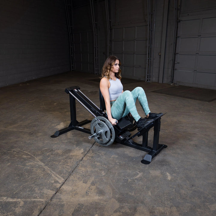 A woman training on the Body-Solid Compact Leg Press GCLP100