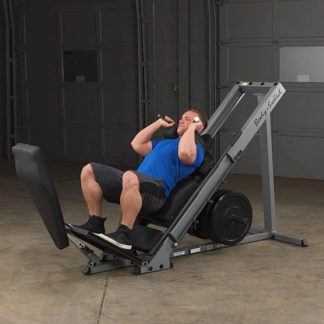A man doing squat training on the Body-Solid Leg Press Hack Squat Machine GLPH1100