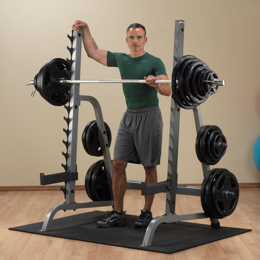 Man showcasing Body-Solid Squat and Bench Rack GPR370