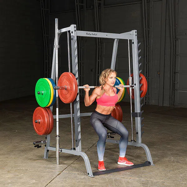 A woman doing squats on the Body-Solid Series 7 Smith Press & Squat Machine GS348Q