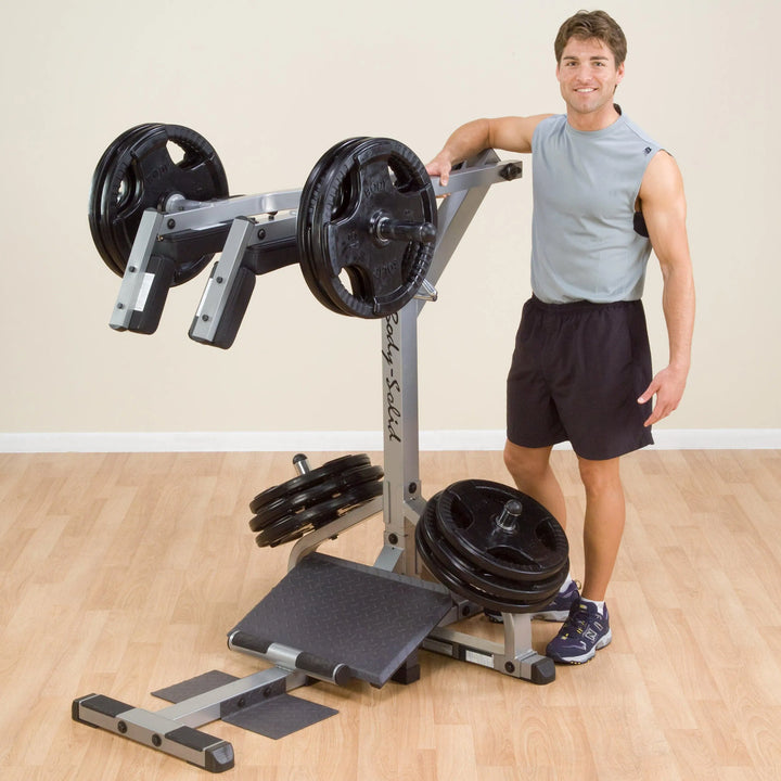 A man showcasing the Body-Solid Assisted Squat Machine GSCL360