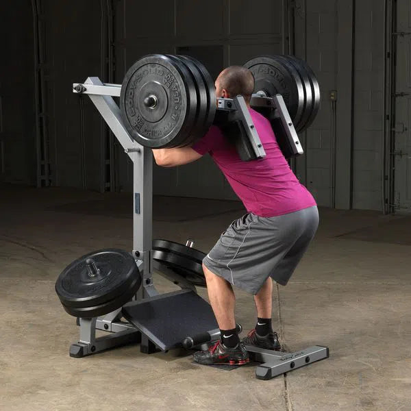 A man training on the Body-Solid Assisted Squat Machine GSCL360