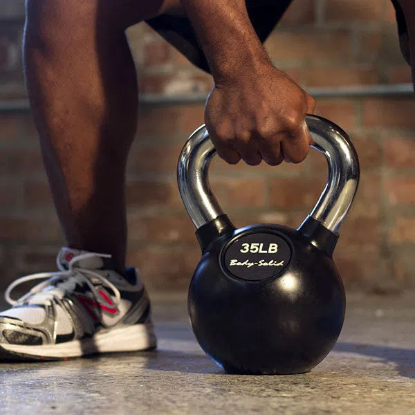 A man training  with a 35lb Body-Solid Full Kettlebell KBC