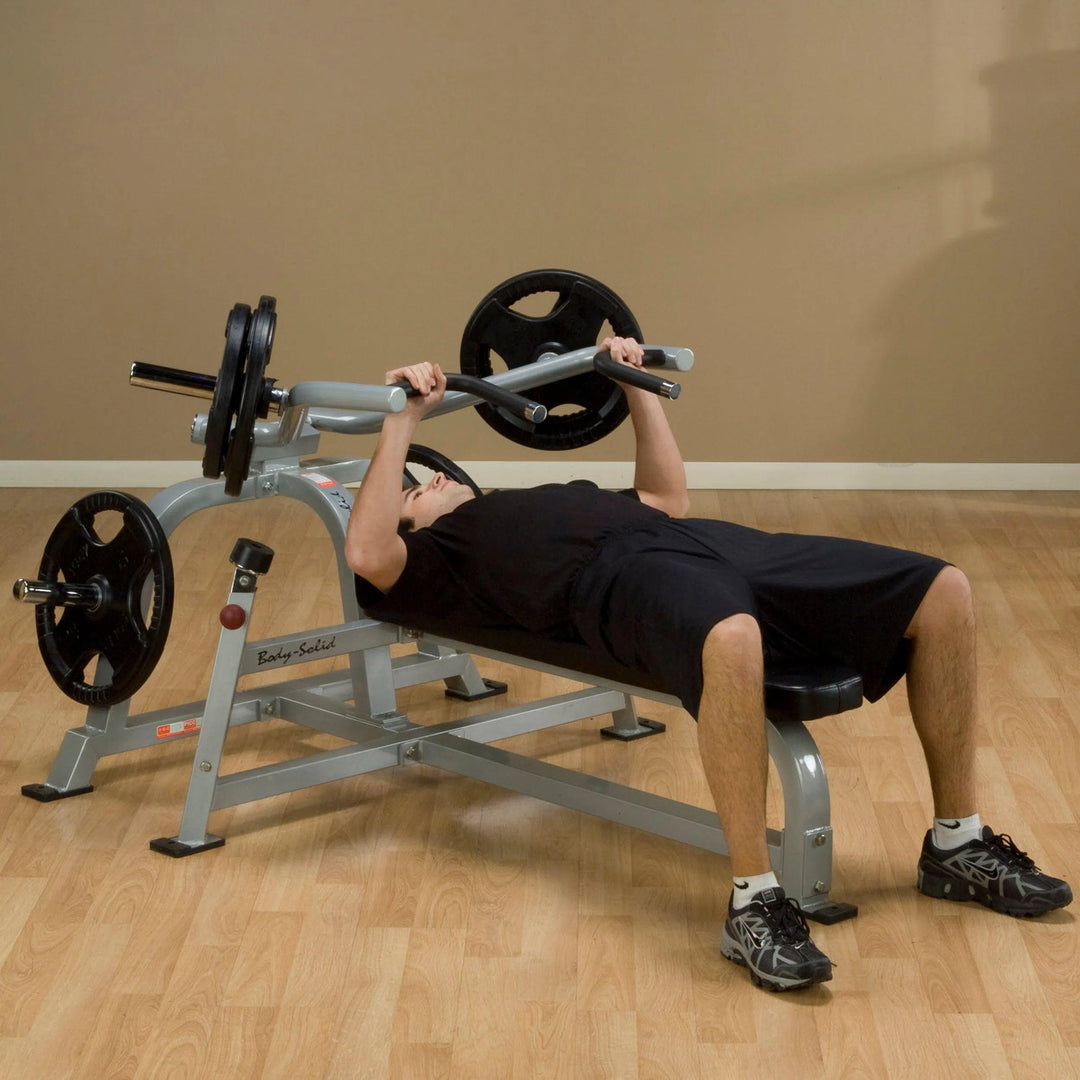 A man training on the Body-Solid Bench Press Machine LVBP