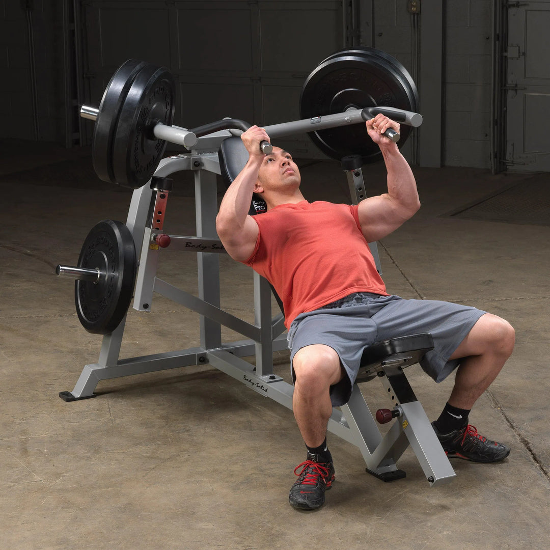 A man training on the Body-Solid Incline Bench Press Machine LVIP