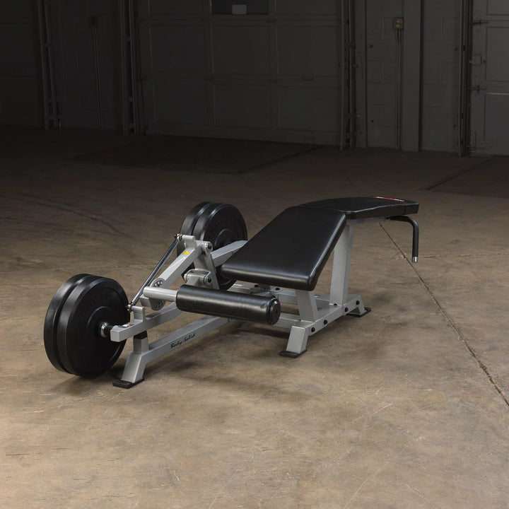 Body-Solid Leg Curl Machine LVLC on display with weight plates