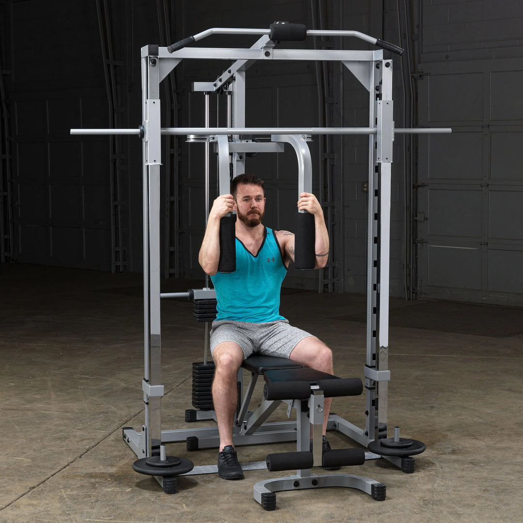 A man doing pec flies on the Body-Solid Powerline Home Smith Machine PSM1442XS