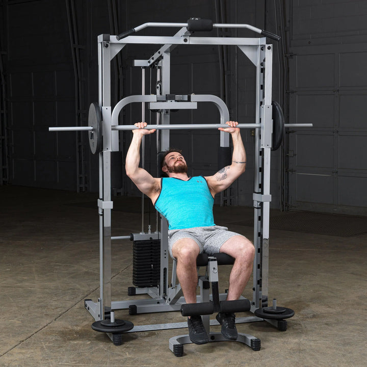 A man doing incline presses on the Body-Solid Powerline Home Smith Machine PSM1442XS