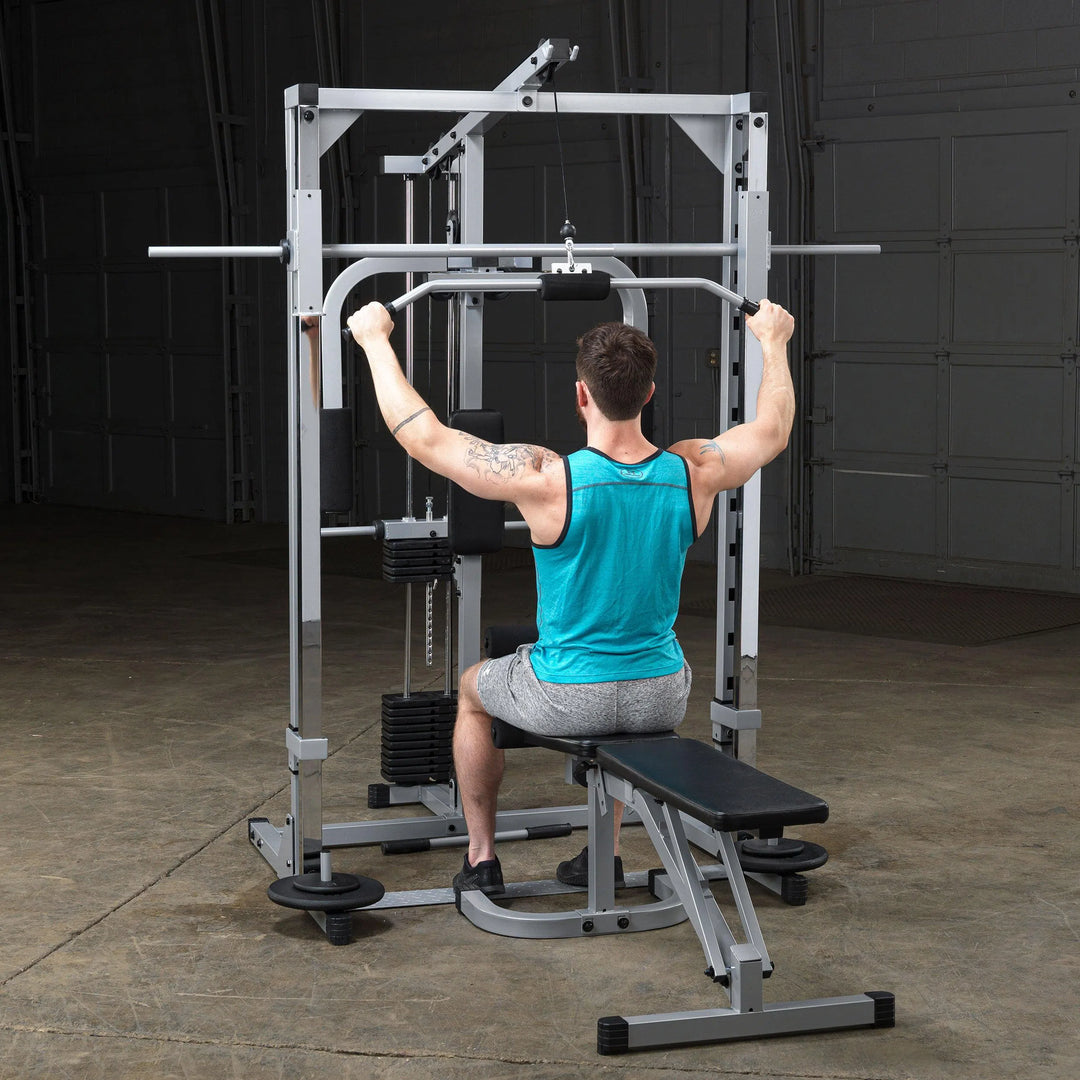 A man doing lat pulldowns on the Body-Solid Powerline Home Smith Machine PSM1442XS
