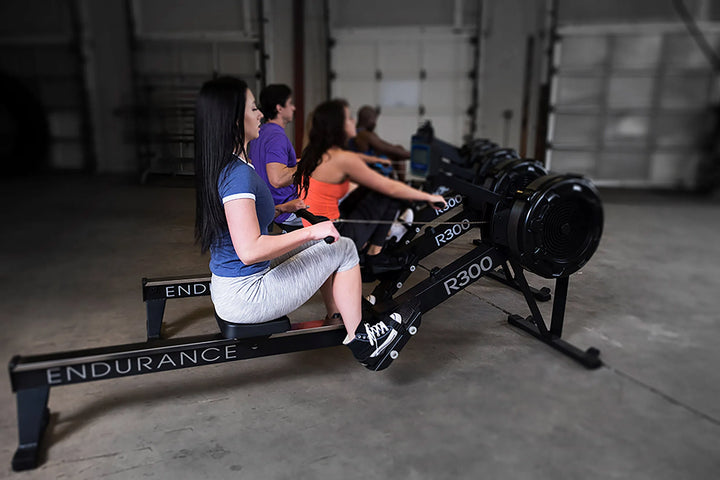 A group of people training together each with a Body-Solid Endurance Commercial Rowing Machine R300