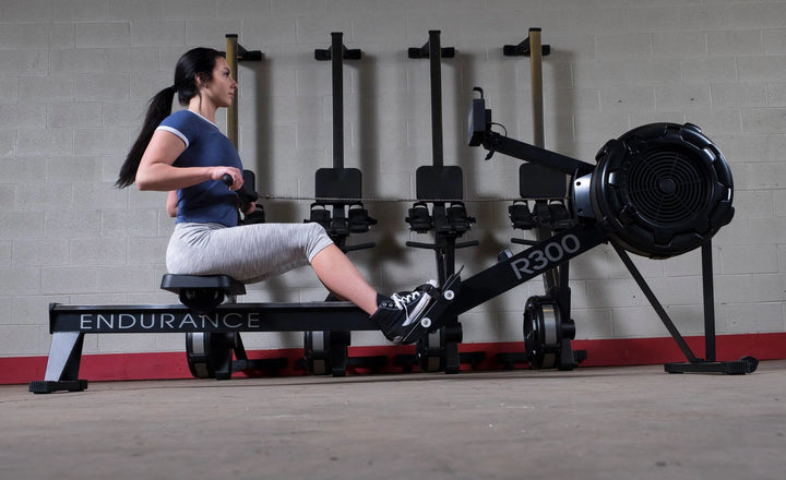 A woman training with a Body-Solid Endurance Commercial Rowing Machine R300