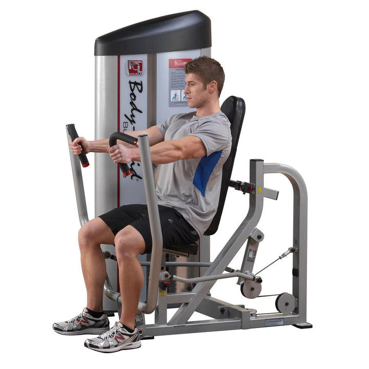 A man training on the Body-Solid Cable Chest Press S2CP