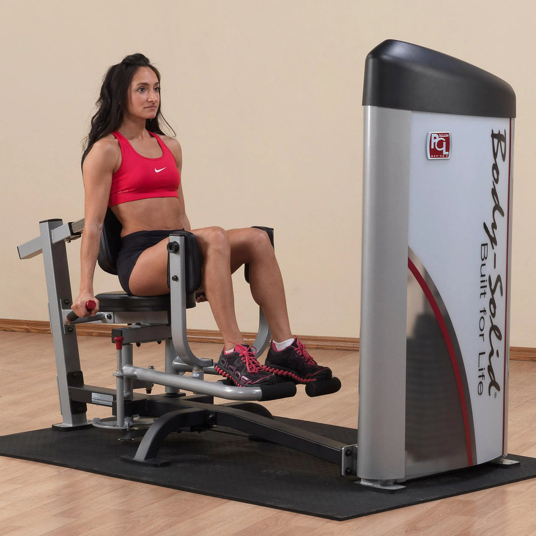 A woman training on the Body-Solid Hip Abduction Abductor Machine S2IOT