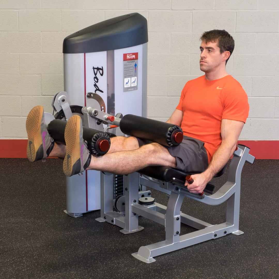 A man training on the Body-Solid Leg Curl and Extension Machine S2LEC
