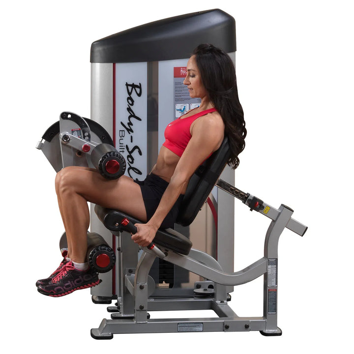 A woman training on the Body-Solid Seated Leg Curl Machine S2SLC