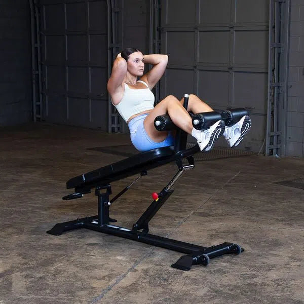 A woman doing decline crunches on the Body-Solid Commercial Sit Up Bench SAB500