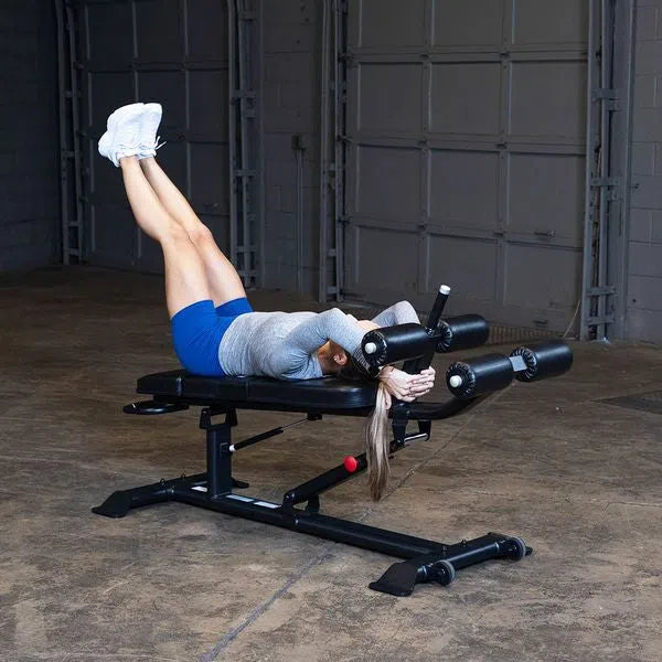 A woman doing leg raises on the Body-Solid Commercial Sit Up Bench SAB500