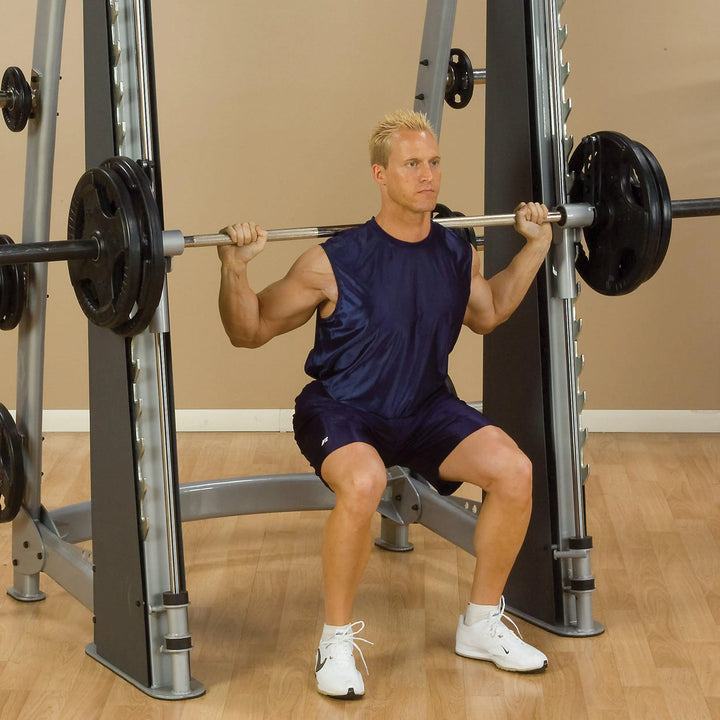 A man doing back squats on the Body-Solid Commercial Smith Machine SCB1000