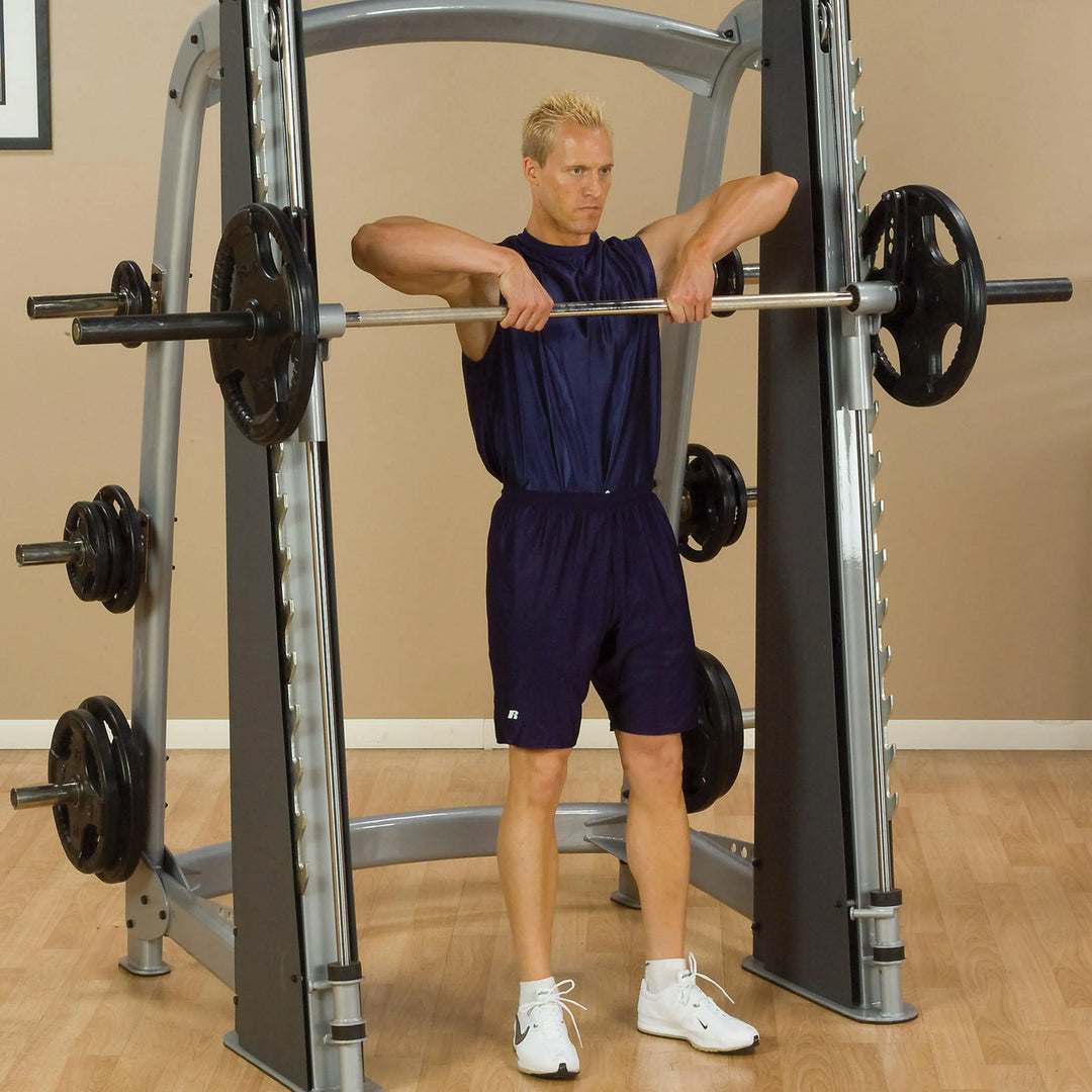 A man training on the Body-Solid Commercial Smith Machine SCB1000